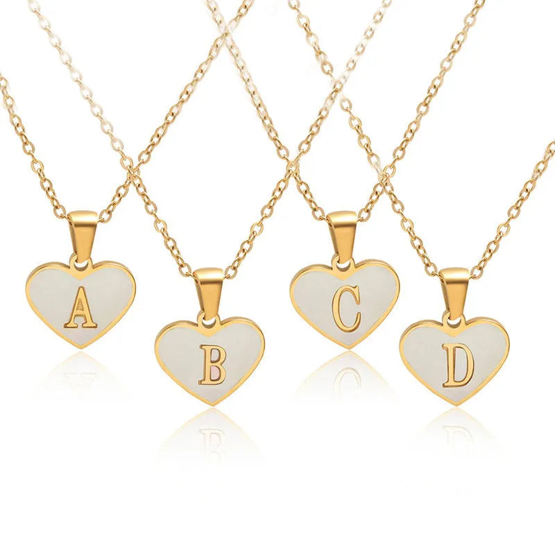 Gold-plated heart-shaped white shell pendant necklace on a stainless steel chain with extendable clasp