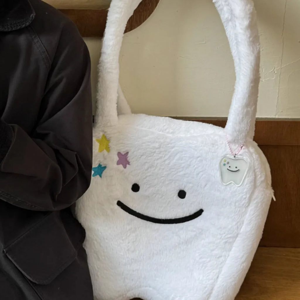 White plush shoulder tote bag with large tooth design and crossbody strap