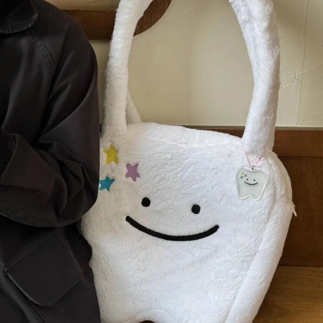 White plush shoulder tote bag with large tooth design and crossbody strap