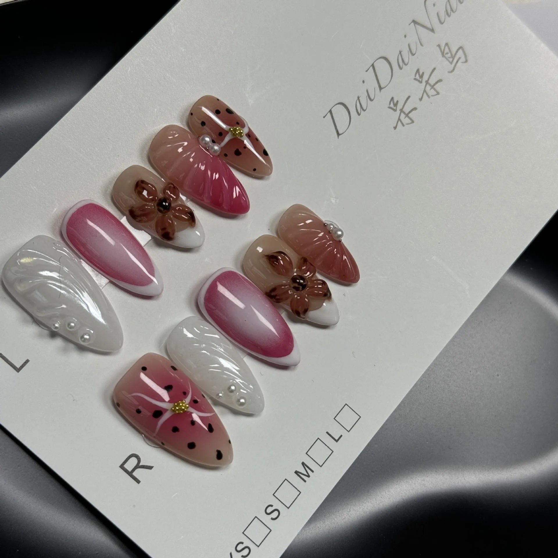 Hand-painted three-dimensional nail art patches with embossed candy patterns in almond shapes