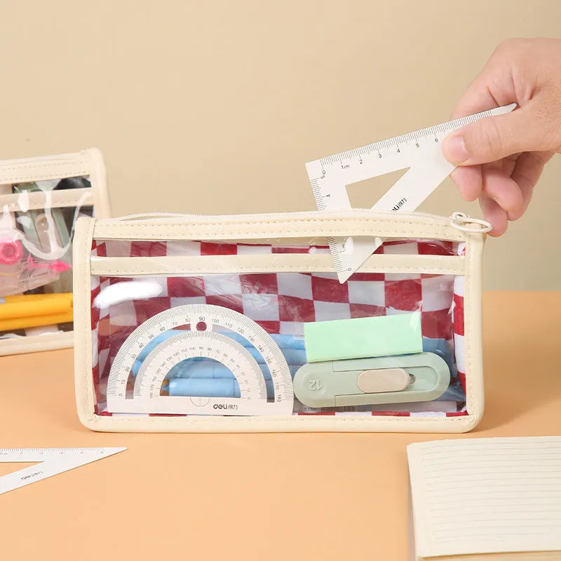Transparent PVC pencil case with chessboard grid pattern showing pens inside, measuring 21.5cm long