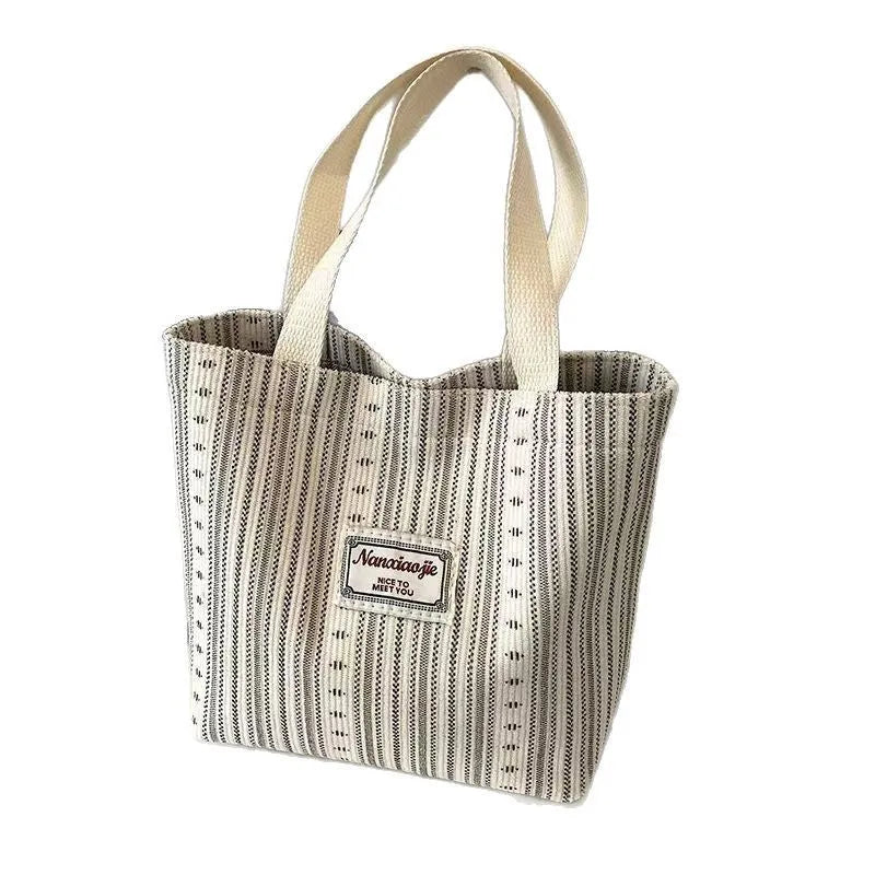 Japanese style corduroy shoulder bag in dark brown colour showing textured fabric and large main compartment