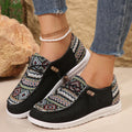 Women's black flat casual shoes with round toe and low-top design on a neutral background
