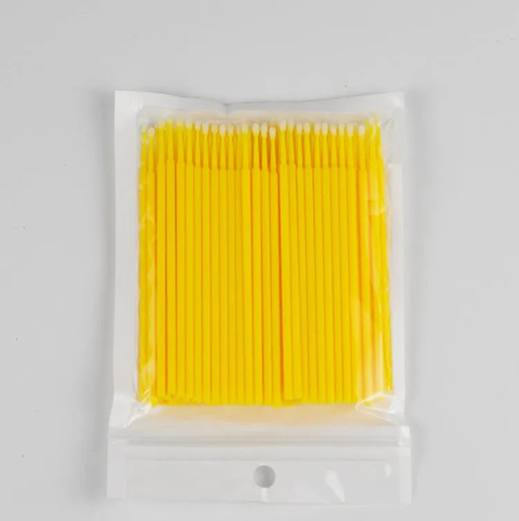 Disposable micro applicator brushes with bendable cotton tips and colour-coded handles for eyelash extensions