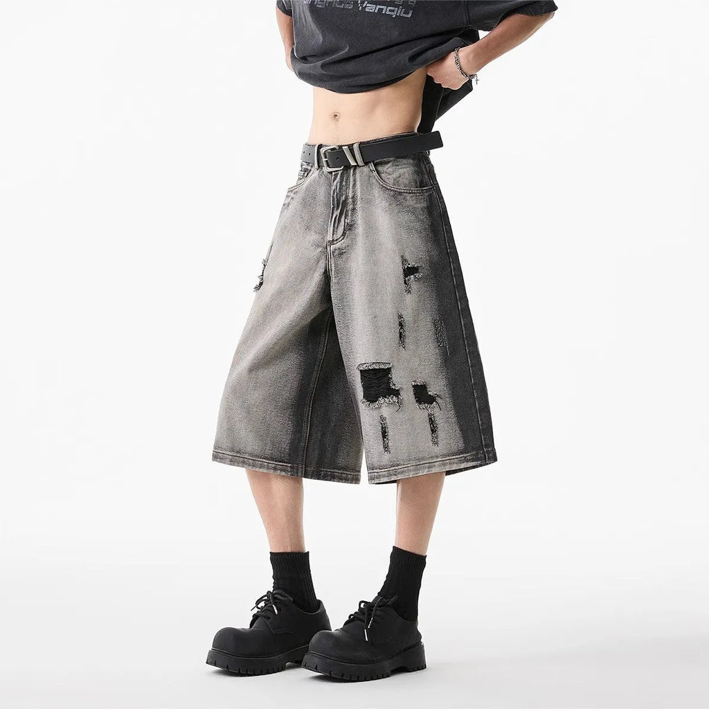 Grey washed denim shorts with distressed holes, loose-fit cropped design for summer casual wear