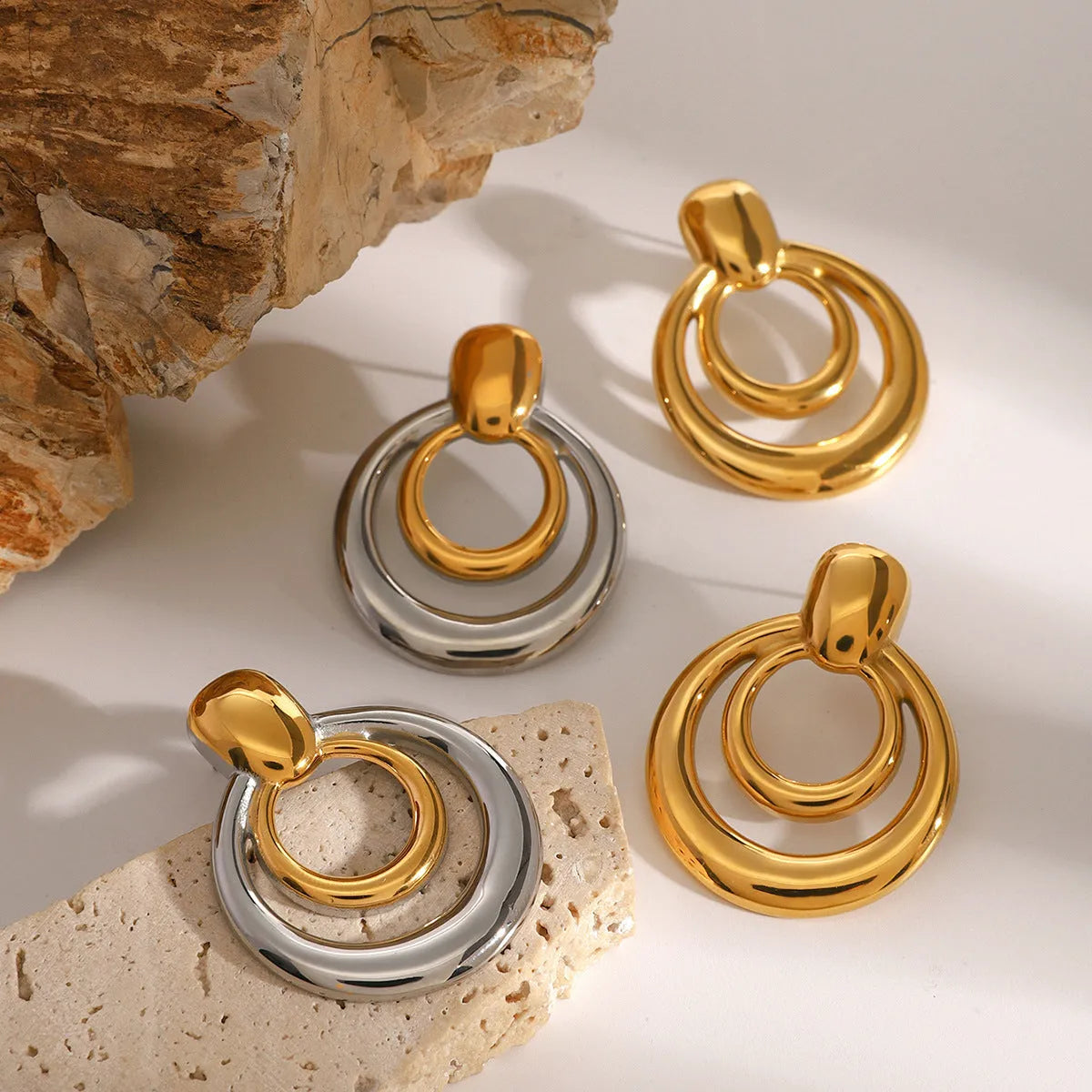 Golden round stud earrings with double-layer hollow construction and contemporary geometry design