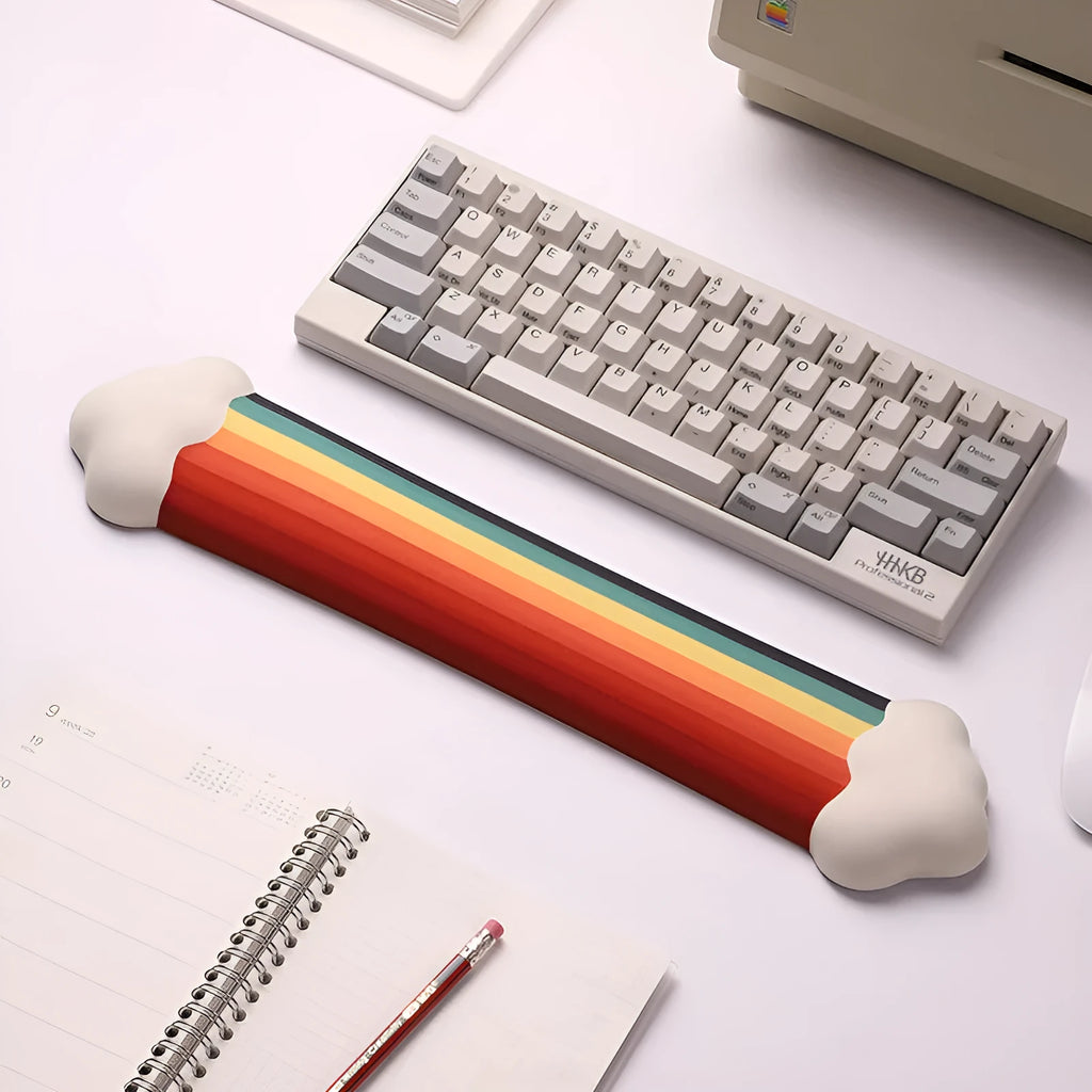 Silicone wrist rest and keyboard support mat set with printed white cloud pattern on a desk.
