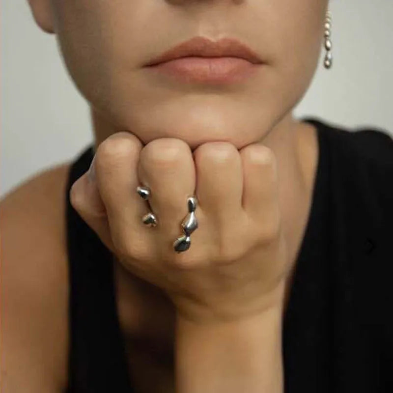 Women's brass open ring with spherical elements in gold finish showing adjustable band design