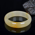 Natural light jade bracelet for women showing polished Chinese style design on wrist