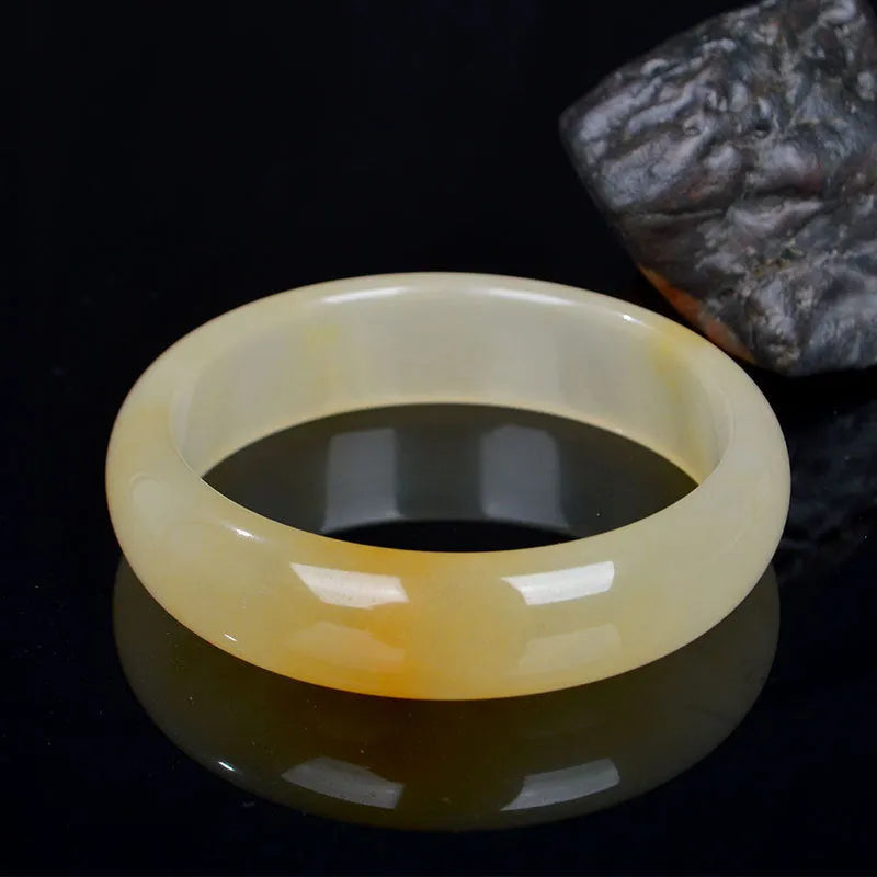 Natural light jade bracelet for women showing polished Chinese style design on wrist