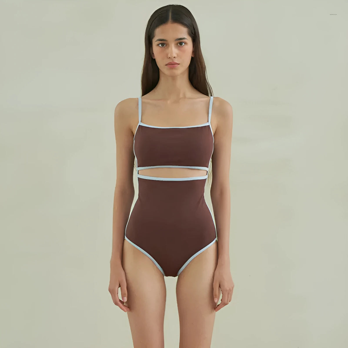 Brown women's one-piece swimsuit with triangle style on a hanger.