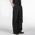 Black straight-leg trousers with a single front pleat and adjustable waistband on a hanger.
