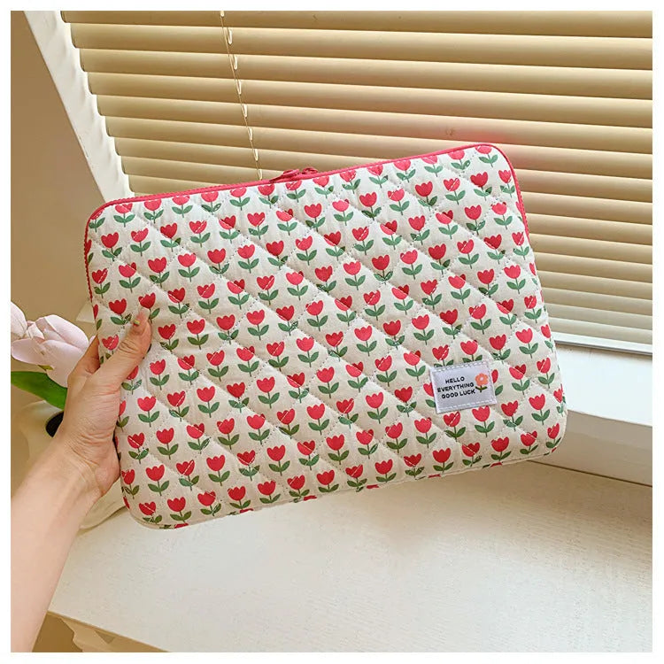 Printed cloth laptop bag for women shown in floral and heart patterns, available in small, medium, and large sizes.