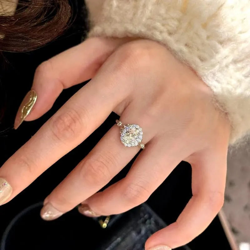 Silver adjustable diamond ring with geometric ellipse shape on finger