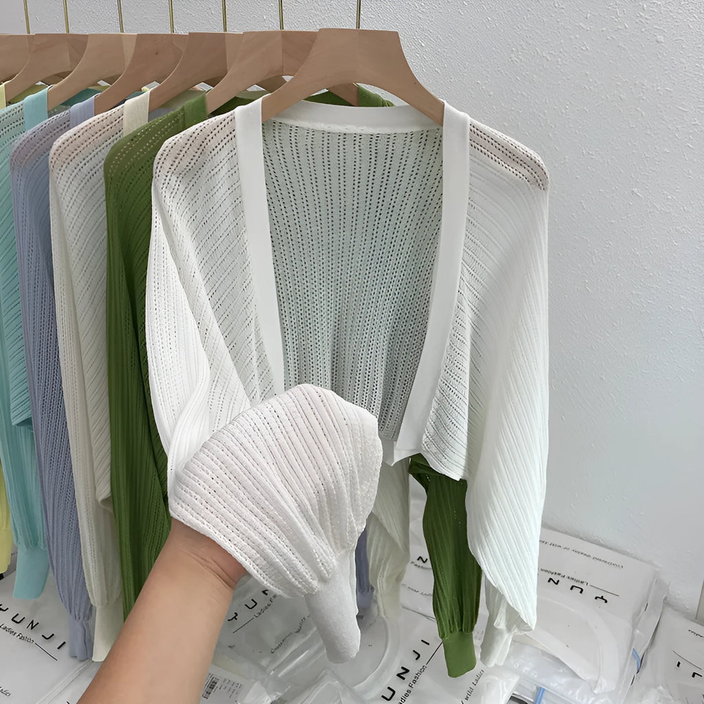 Women's lantern sleeve blouse in apricot colour with hollow thin fabric and long sleeves.