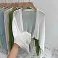 Women's lantern sleeve blouse in apricot colour with hollow thin fabric and long sleeves.