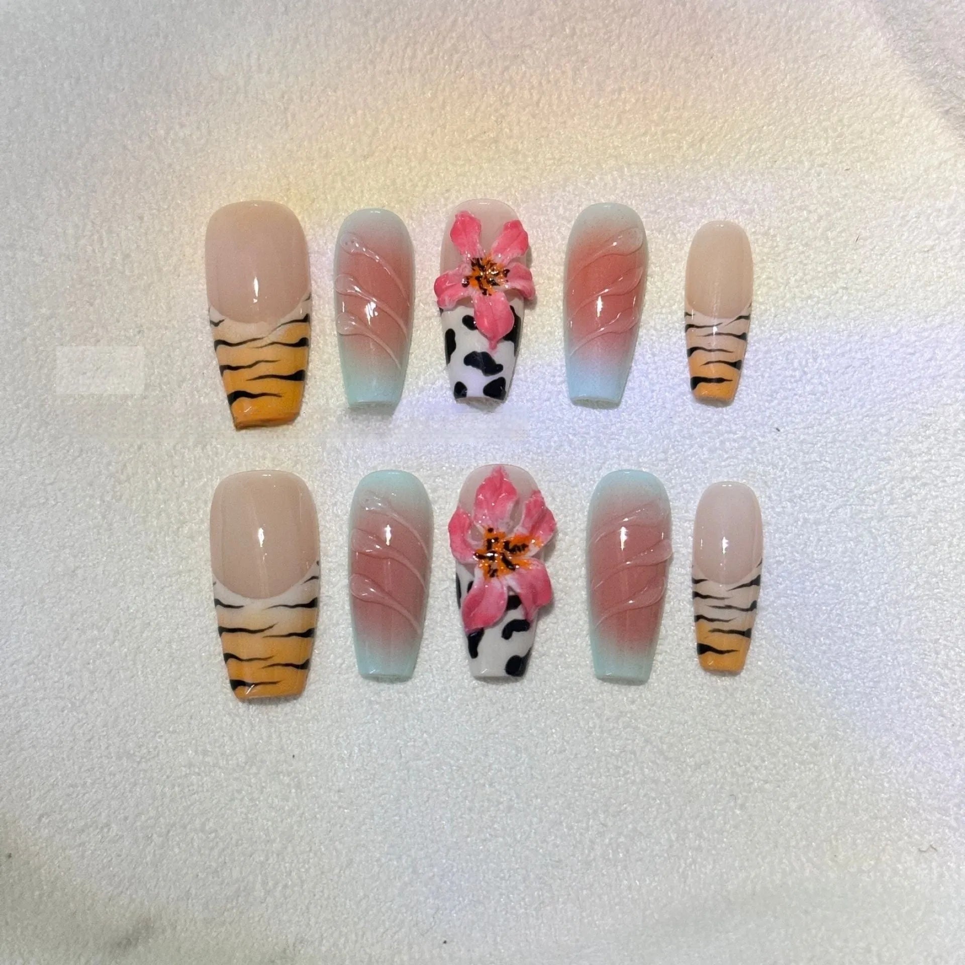 Zebra pattern Lily hand carving nail art with embossed flower designs in four sizes