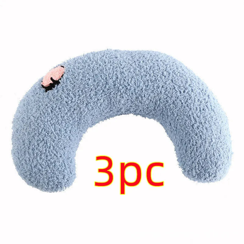 Small blue half-donut shaped pet pillow bed for cats or small dogs on a carpet.