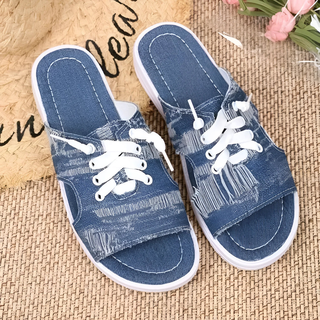Blue Roman style flat canvas slippers for women with a rubber sole.
