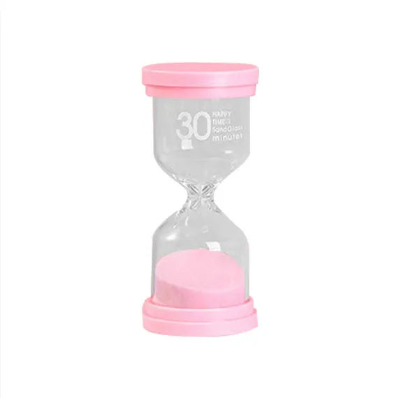 Handmade glass sand timer hourglass in blue, green, pink or purple on a desk.