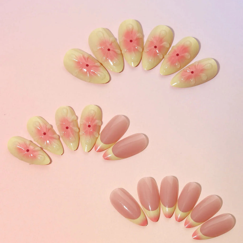 Simple fake nails set with pink and white 3D cartoon flower designs on detachable plastic armour pieces.