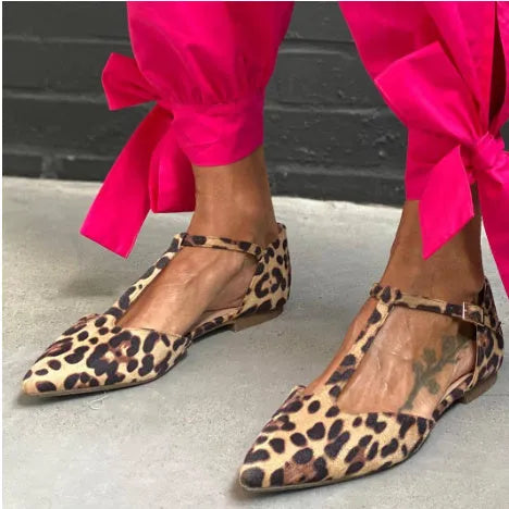 Leopard print women's pumps with a pointed toe, chunky low heel, and an ankle strap.