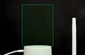 3D acrylic message board night light with remote control on a desk, showing 16 colour options.