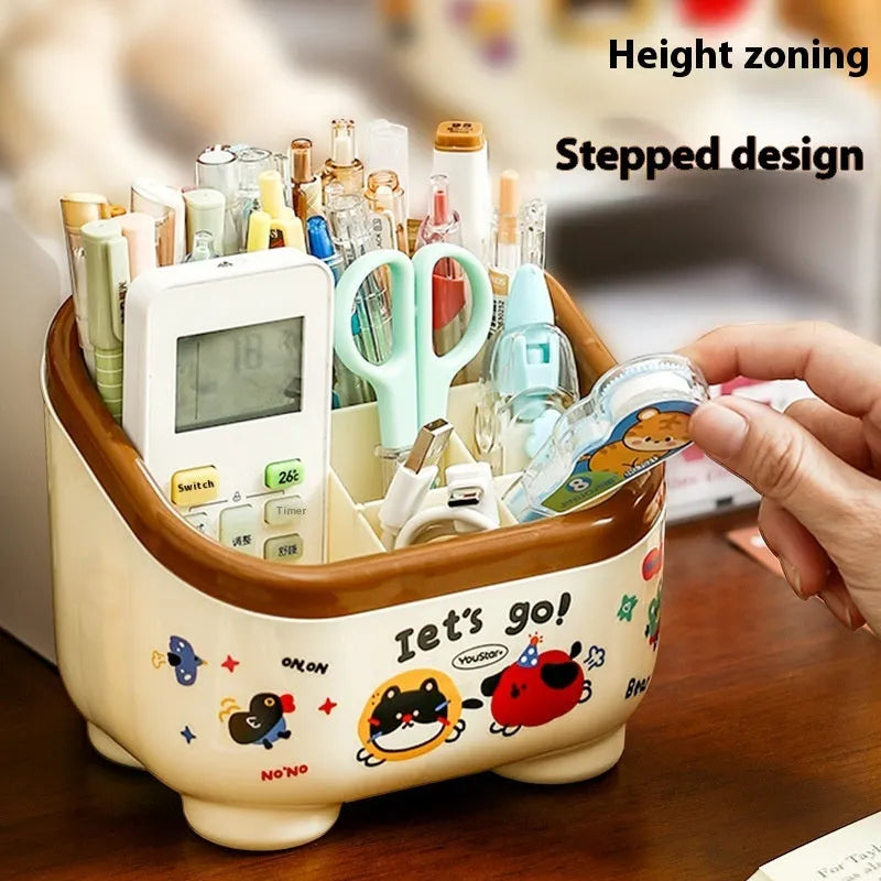 Cartoon-style plastic desktop organiser with grid compartments and labelling stickers for stationery storage