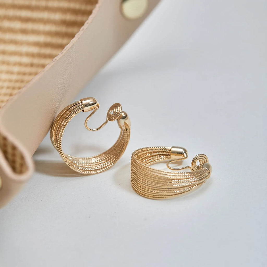 Geometric copper earrings in silver and gold finishes as clip-on and stud styles