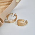 Geometric copper earrings in silver and gold finishes as clip-on and stud styles