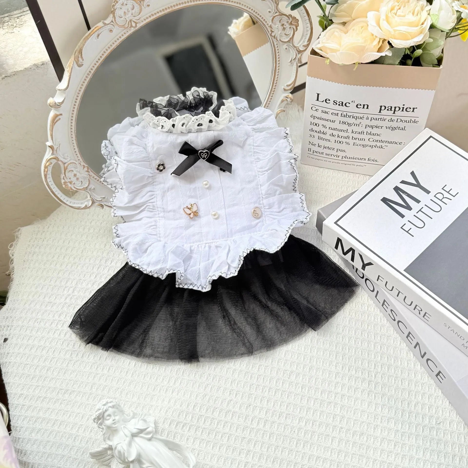 White polyester princess style gauze skirt for a small dog on a hanger, showing the layered skirt design.