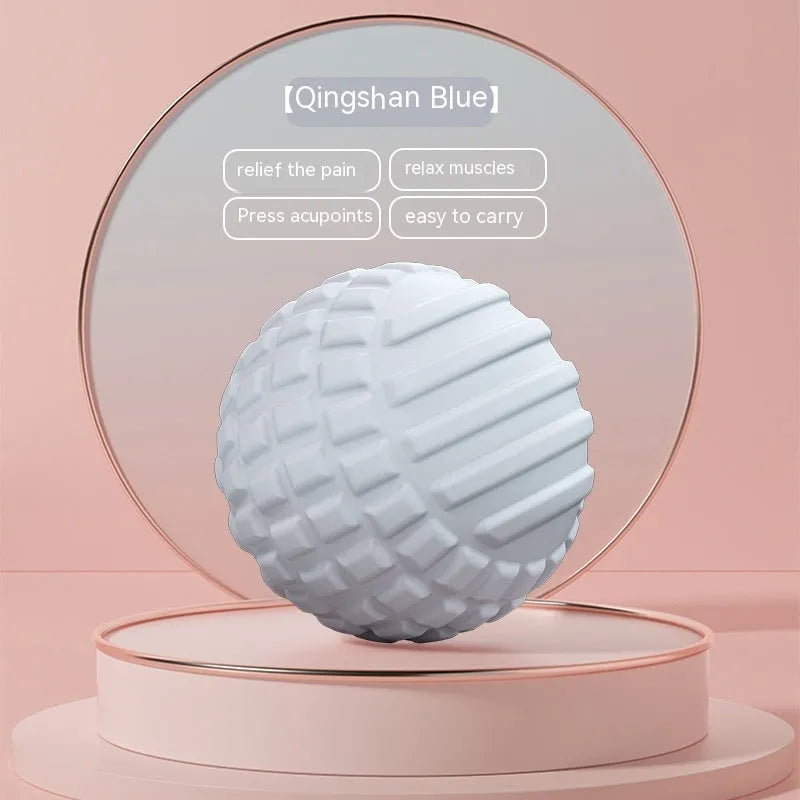 Blue TPR foot massage ball with textured surface shown next to foot for scale