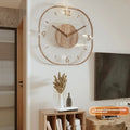 Modern square transparent wooden frame wall clock on a wall, showing visible mechanical movement inside.