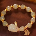 Women's black adjustable bracelet with green jade fu character, jade hare charm, and Lily decorations.