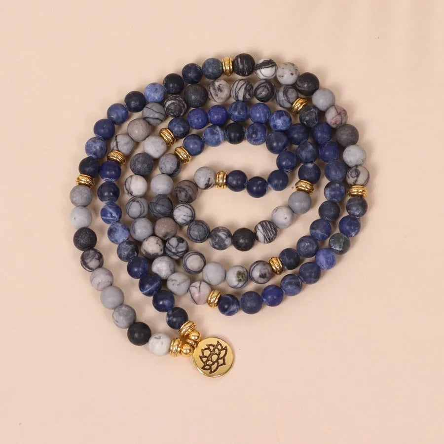Blue patterned network stone beads on a multi-layer bracelet with an alloy clasp.