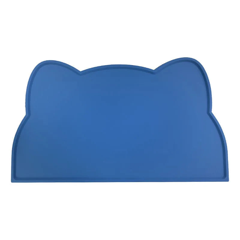 Blue silicone pet feeding mat with cat head shape under dog bowl