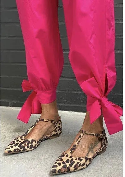 Leopard print women's pumps with a pointed toe, chunky low heel, and an ankle strap.