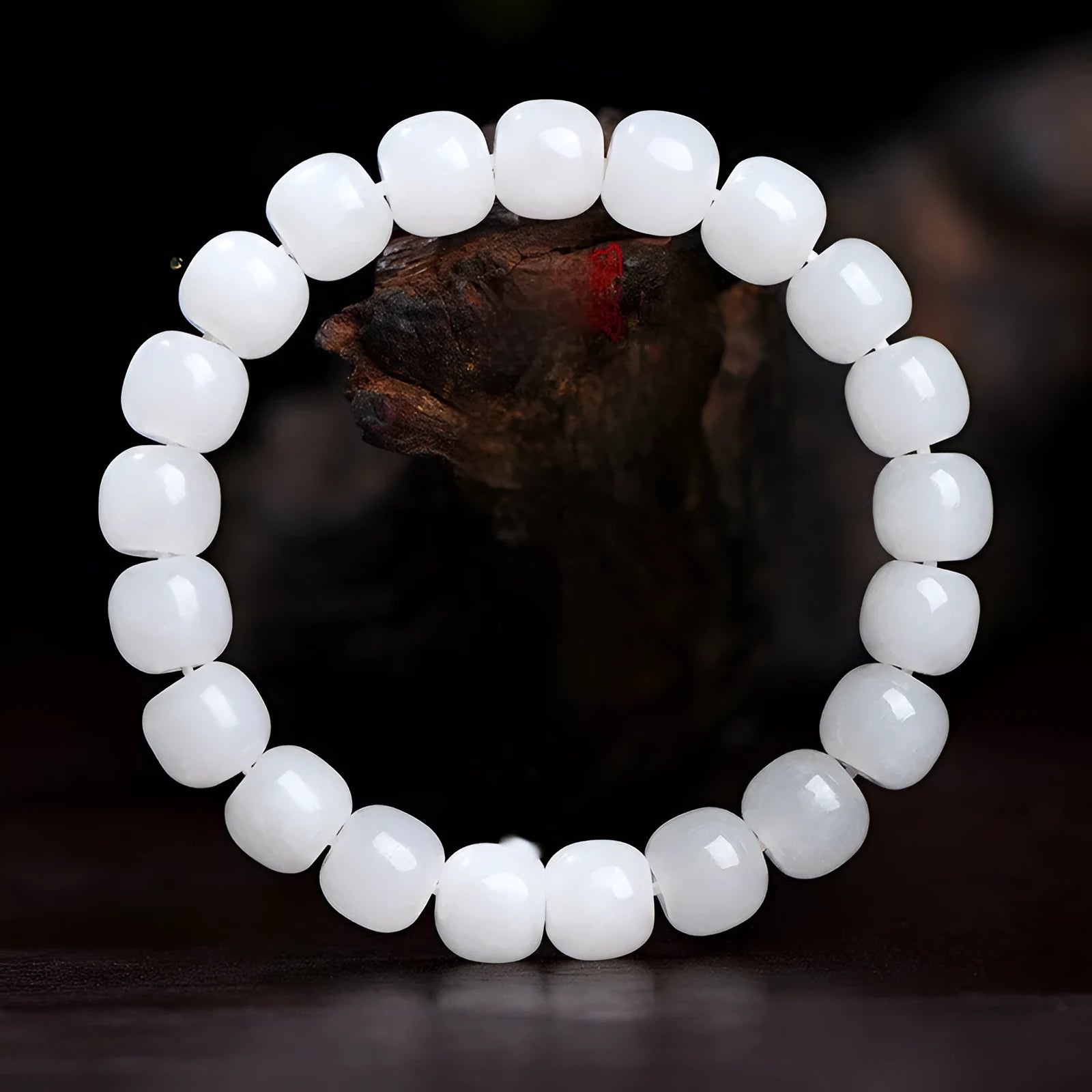White Hetian jade barrel bead bracelet for men and women on a wrist.
