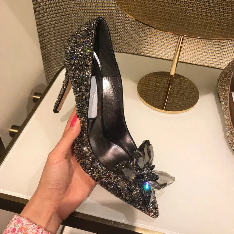 Women's gold high heel shoes with rhinestone detailing and pointed toe design