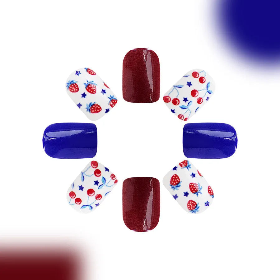 Short glossy press-on nails with strawberry and cherry图案 in red and blue colours