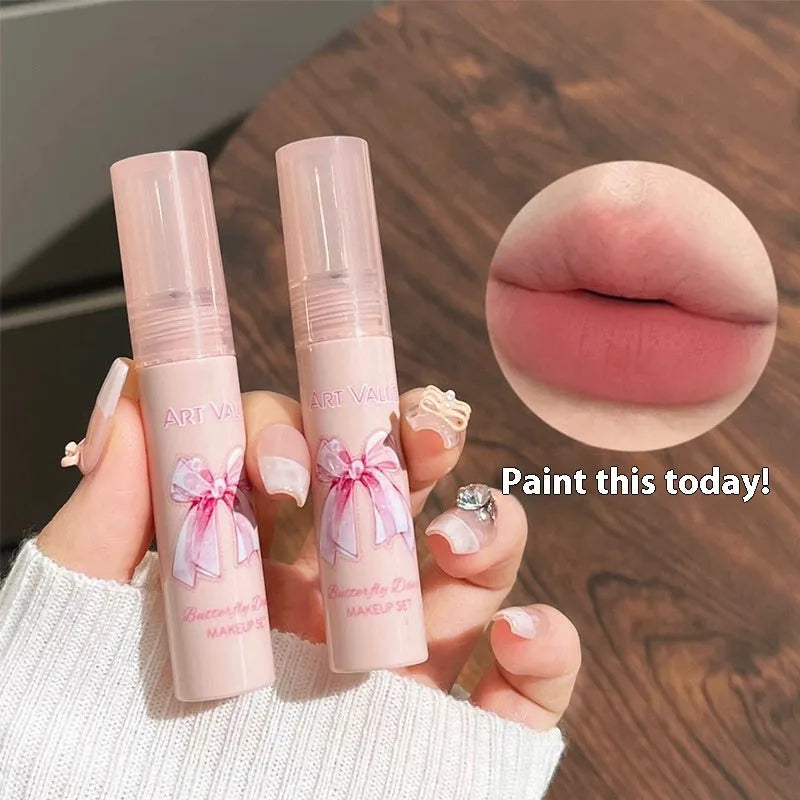 Butterfly Box makeup set containing four pink matte lip muds, one powder blusher, and a butterfly necklace in standard packaging.