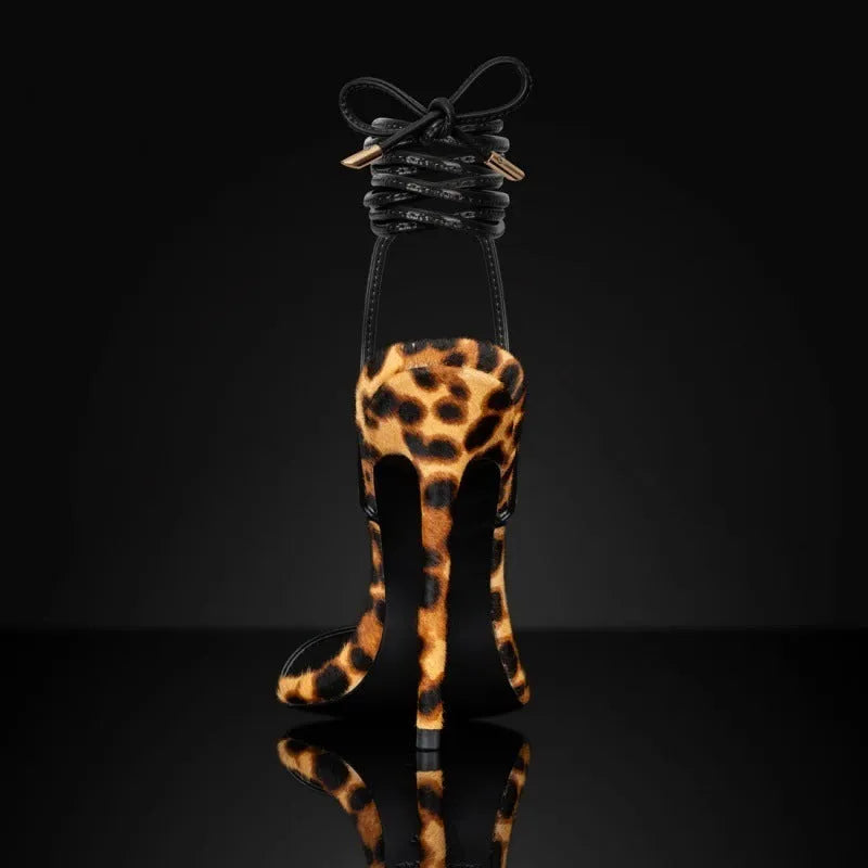 Women's leopard print pointed toe sandals with lace-up buckle straps on a flat rubber sole.