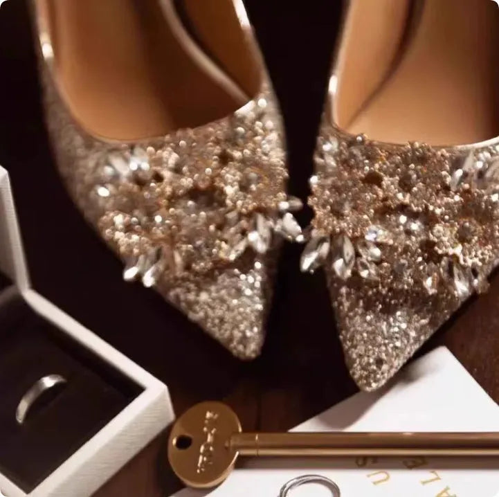 Champagne coloured women's wedding high heel shoes with crystal decoration and a pointed toe.