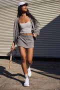 Women's blue polyester hooded jacket and matching mini skirt co-ord set shown together, featuring a zip detail.