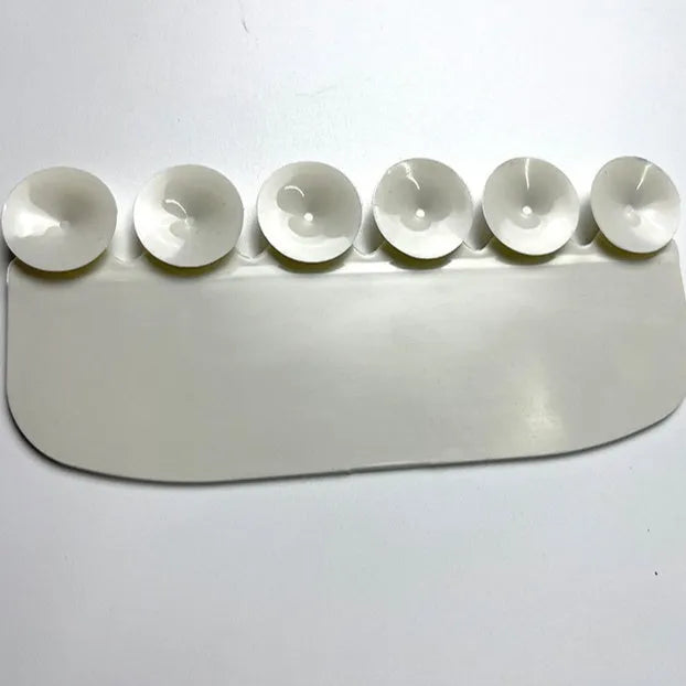 White PVC urine blocking board for children's toilet training placed around toilet bowl
