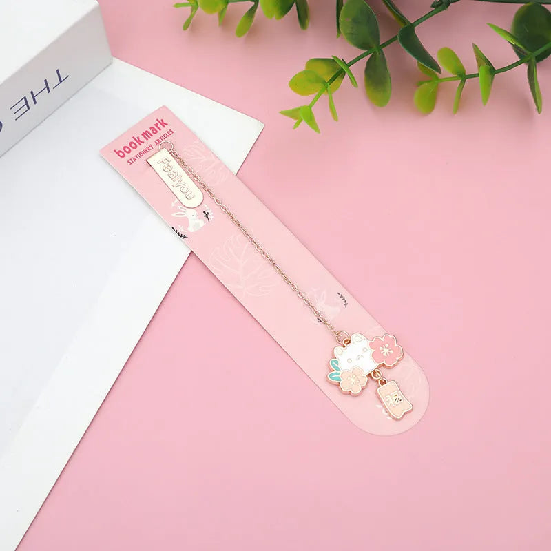 Metal book holder with cherry cat pendant decoration for journals and books