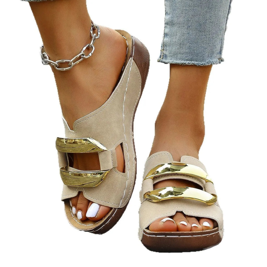 Women's white Roman style platform sandals with metal detail on a flat rubber sole.