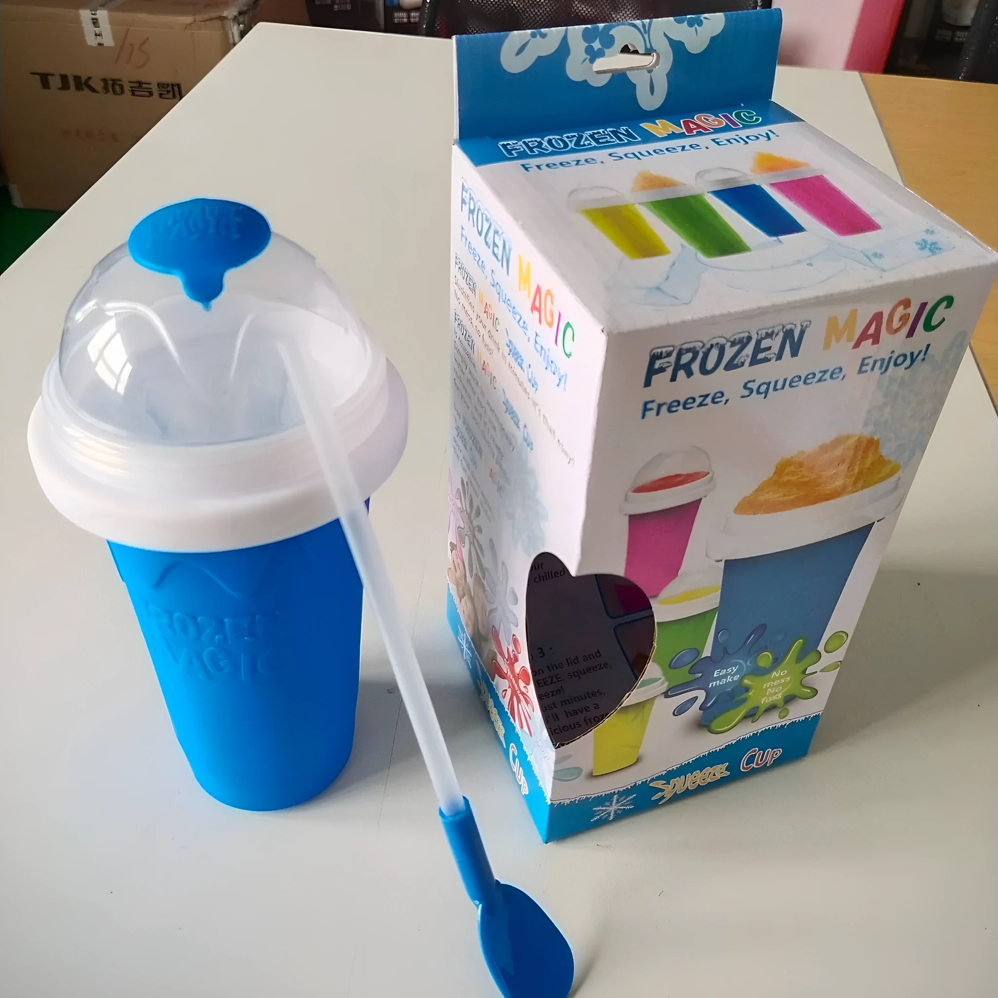 Blue double wall silicone cold shake cup with cylindrical shape and pinch activation for instant beverage cooling