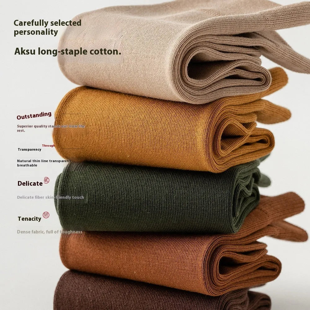 A pair of solid colour men's mid-calf socks in combed cotton, shown in a light grey shade.