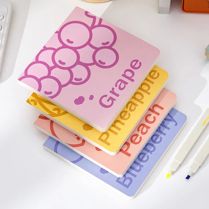 Square notebook with embossed fruit design cover, showing 14.5 cm dimensions and open pages.